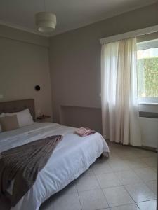 a bedroom with a large bed and a window at "Alsos View" in Agrinio