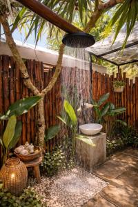a bathroom with a sink and a tree at Bubble 4 - Romantic With Bath Uluwatu in Uluwatu +16 photos