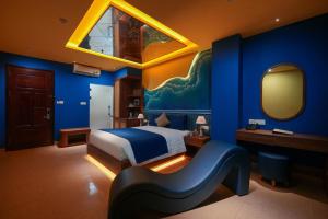 a bedroom with a bed and a blue wall at Chiic House Hải Phòng in Lực Hánh