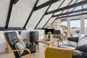 a living room with a couch and a table at 274-Ringkobing-Nordso-Ferievej-86 in Nørre Lyngvig