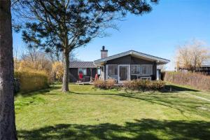 a small house in a yard with a tree at FY298-Faaborg-Dybskrog-12 in Faaborg