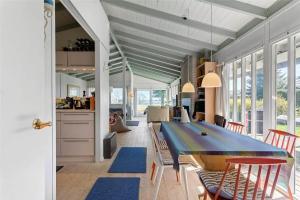 a kitchen and dining room with a blue table and chairs at FY298-Faaborg-Dybskrog-12 in Faaborg