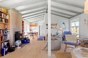 a living room with a couch and a fireplace at FY298-Faaborg-Dybskrog-12 in Faaborg