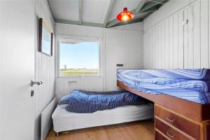 a bedroom with a bunk bed and a window at FY298-Faaborg-Dybskrog-12 in Faaborg