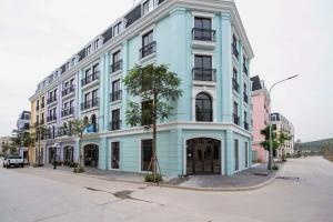 a blue and white building on a city street at Villa 184 HABOBAY in Ha Long