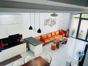 a living room with a couch and a table at Villa 184 HABOBAY in Ha Long