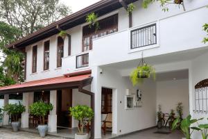 a white building with plants in front of it at Villa Barracuda in Sri Jayewardenepura Kotte