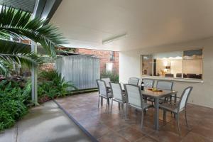 a patio with a table and chairs and plants at Rawson's Retreat - Five Bedroom Home - Walk CBD - Includes Breakfast in Tamworth