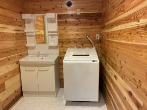 a bathroom with wooden walls and a sink and a counter at ヴィラ湖西 最大11名 琵琶湖ビュー165平米の一棟貸切ログハウス BBQハウス完備 広々3LDK ロフト Wi-Fi in Takashima +35 photos