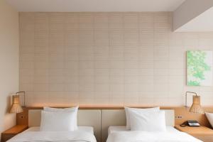 A bed or beds in a room at Nagoya JR Gate Tower Hotel