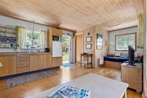 a kitchen with wooden ceilings and a living room at SL078-Slagelse-Dybkaervej-36 in Slagelse +19 photos