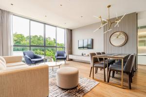 a living room with a table and chairs at GreenLa by Villacarte in Layan Beach
