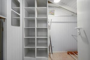 a white closet with empty shelves in a room at 30305-Ulfborg-Bellisvej-504 in Ulfborg +24 photos