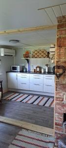 a kitchen with white cabinets in a room at Welcome to Lillstugan in Jämshög