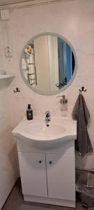 a bathroom with a white sink and a mirror at Welcome to Lillstugan in Jämshög +17 photos