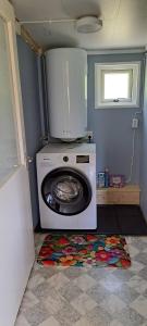 a washing machine in a room with a window at Welcome to Lillstugan in Jämshög