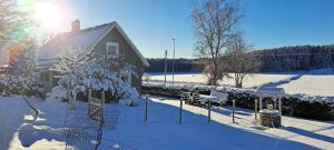 a house with a fence in the snow at Welcome to Lillstugan in Jämshög