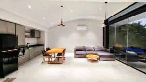 a living room with a couch and a table at Villa Lumina, Koh Samui in Chaweng Noi Beach