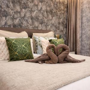 two snakes sitting on top of a bed at Moonlit Terrace Escape in St. Paul's Bay