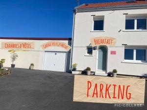 a parking sign in front of a white building at Séverine chambres d’hôtes in Floing