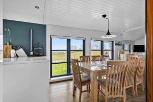 a kitchen and dining room with a table and chairs at SB122-Augustenborg-Gronvej-3 in Asserballeskov