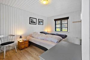 a bedroom with a bed and a table and a chair at SB122-Augustenborg-Gronvej-3 in Asserballeskov