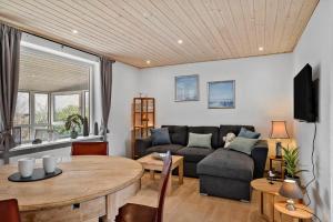 a living room with a couch and a table at LF10243-Thyholm-Krumborgvej-3 in Hvidbjerg