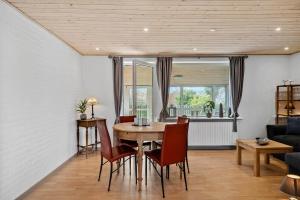 a dining room with a table and chairs at LF10243-Thyholm-Krumborgvej-3 in Hvidbjerg