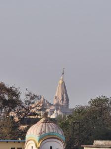 a building with a flag on top of it at Prem Saroj homestay in Ayodhya