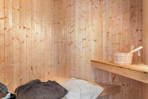 a room with a wooden wall with a wooden shelf at LF12022-Spottrup-Skovmarken-2 in Vadum