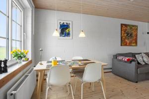 a kitchen and dining room with a table and chairs at FY410-Faaborg-Mosetoften-10-B in Diernæs