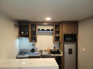 a small kitchen with a stove and a refrigerator at Departamento Ejecutivo Rigo Tovar in Matamoros