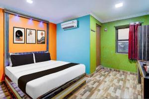 a bedroom with a large bed with colorful walls at KVS Residency in Tiruvallam