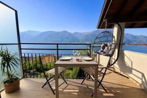 a table and chairs on a balcony with a view at Il Bellavista in Lezzeno +47 photos
