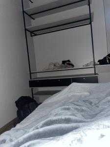 a white bed in a room with a shelf at CampAmbrosi in Sapiranga