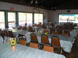 a room full of tables and chairs with tablesktop at Lake of the Springs Camping Resort Cabin 2 in Oregon House