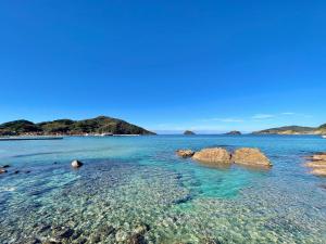 a view of the ocean with rocks in the water at SEABASE villa at shimane in Matsue