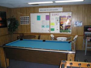 a room with a pool table in front of a wall at Lake Minden Camping Resort Cabin 1 in Nicolaus