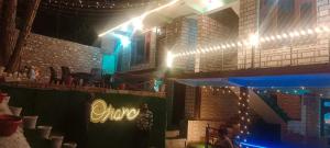 a stage with a sign and lights on it at Onarc guest house in Kasol