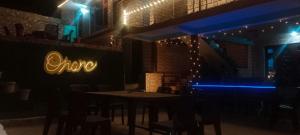 a restaurant with a table and chairs at night at Onarc guest house in Kasol