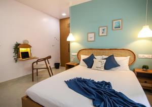 a bedroom with a large bed with blue walls at Nivara Stays Lingampalli, A Boutique Hotel Brand in Hyderabad