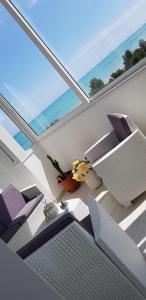 a room with chairs and a table and a large window at CasAmare in Montesilvano