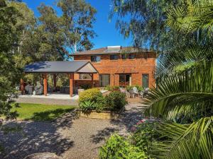 a brick house with a gazebo in a yard at Hunter Homestead in Lovedale