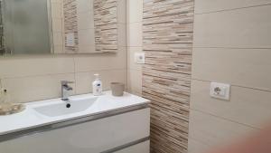 a white bathroom with a sink and a mirror at CasAmare in Montesilvano