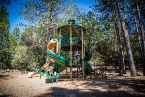 a playground with a slide in a park at Lake of the Springs Camping Resort Cabin 5 in Oregon House