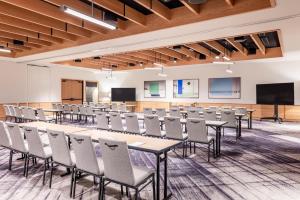 a conference room with tables and chairs and a projection screen at The Shay, a Destination by Hyatt in Los Angeles +91 photos