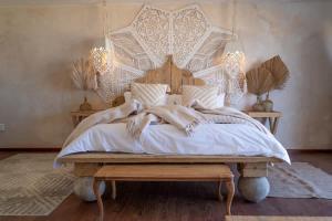 a bedroom with a large bed with a wooden headboard at Art Cabin Beach Villa in Langstrand +33 photos