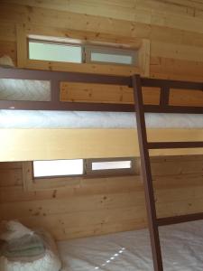 two bunk beds in a wooden cabin at Palm Springs Camping Resort Cabin 3 in Palm Desert