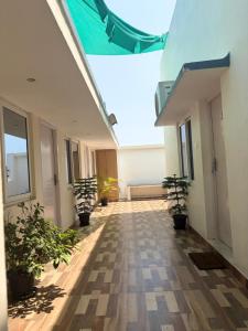 an empty hallway with potted plants in a building at Serenity Beach House in Pondicherry