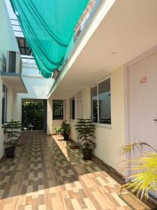 an empty hallway with potted plants in a building at Serenity Beach House in Pondicherry